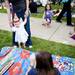 Fiona, 1, walks around with her mother and Top of the Park Communication Specialist Maureen McMahon on Friday, June 21. Daniel Brenner I AnnArbor.com